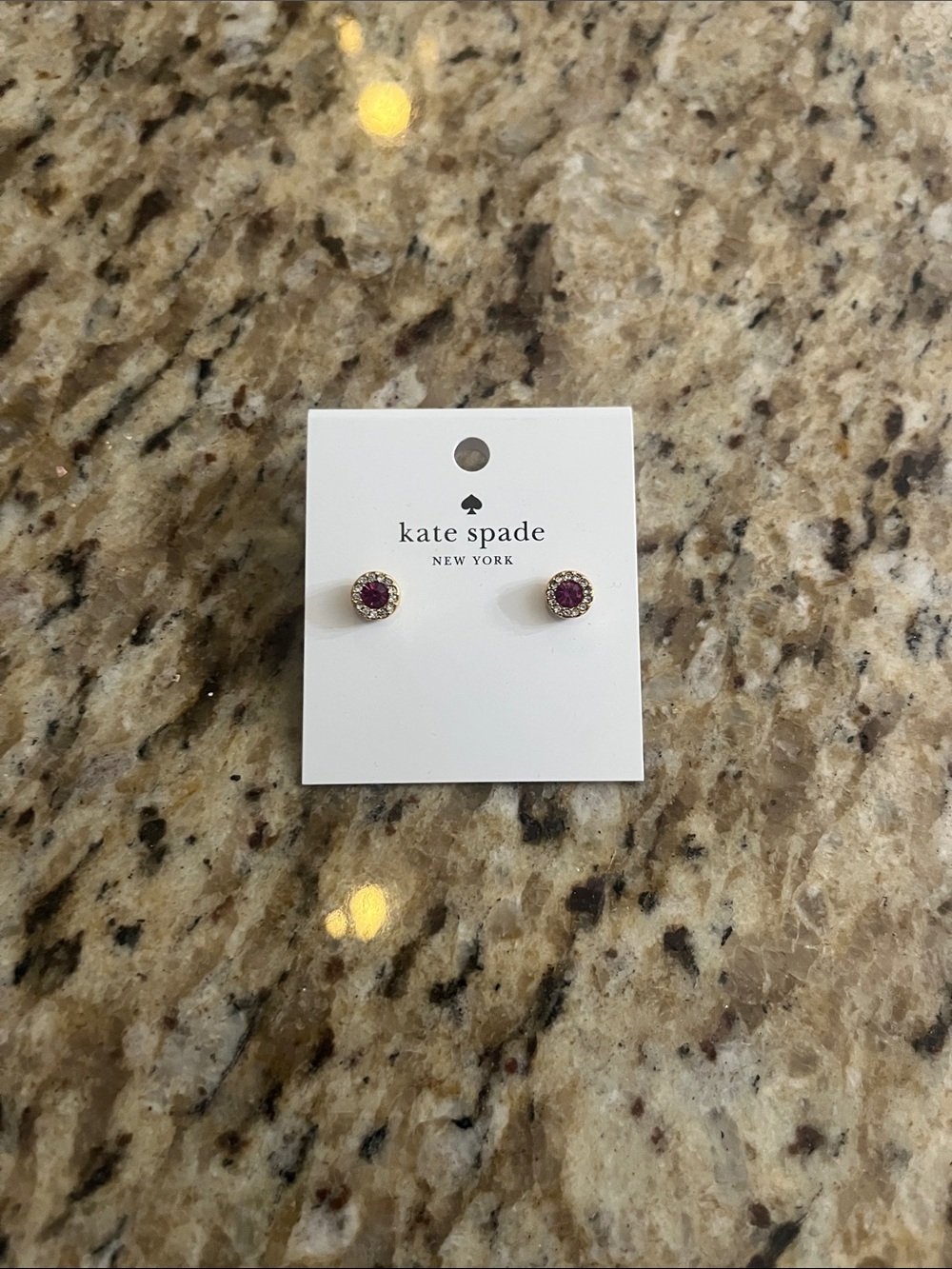 Kate Spade gold-tone stud earrings with magenta center crystals
